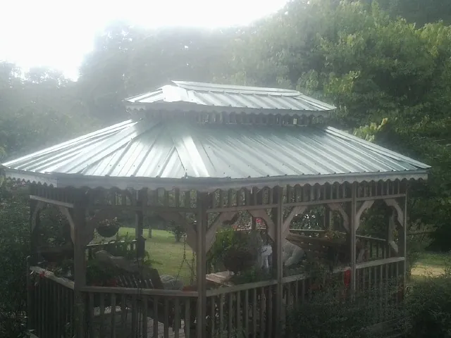 Two tier green metal roof on a garden gazebo in Drayden